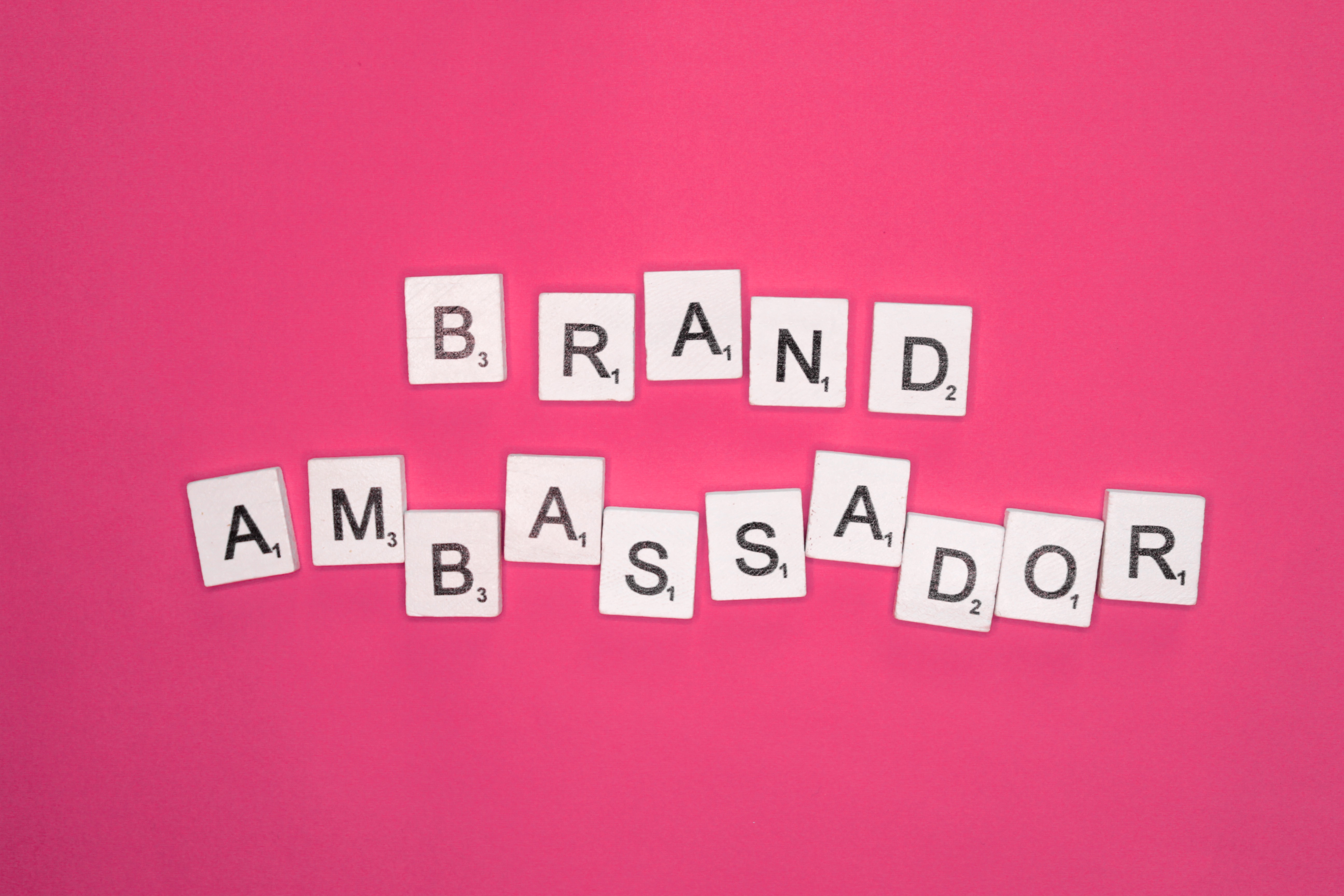 Brand ambassador scrabble letters word on a pink background